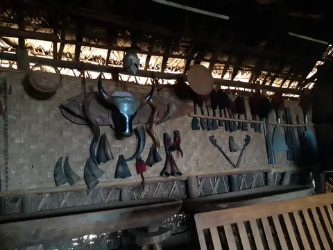 Animal trophies and carvings displayed inside a traditional house